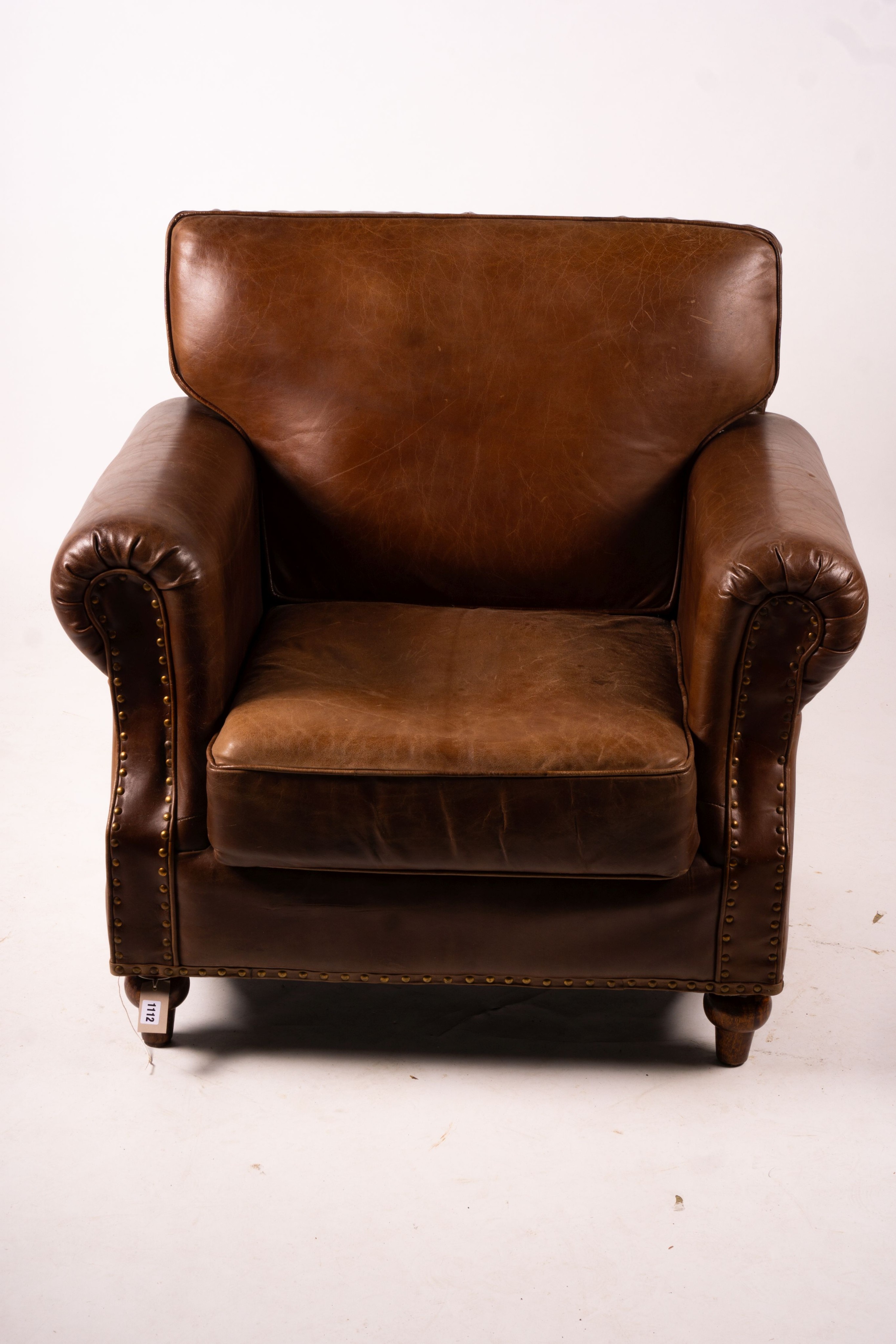 A pair of brown leather club armchairs, width 96cm, depth 80cm, height 90cm